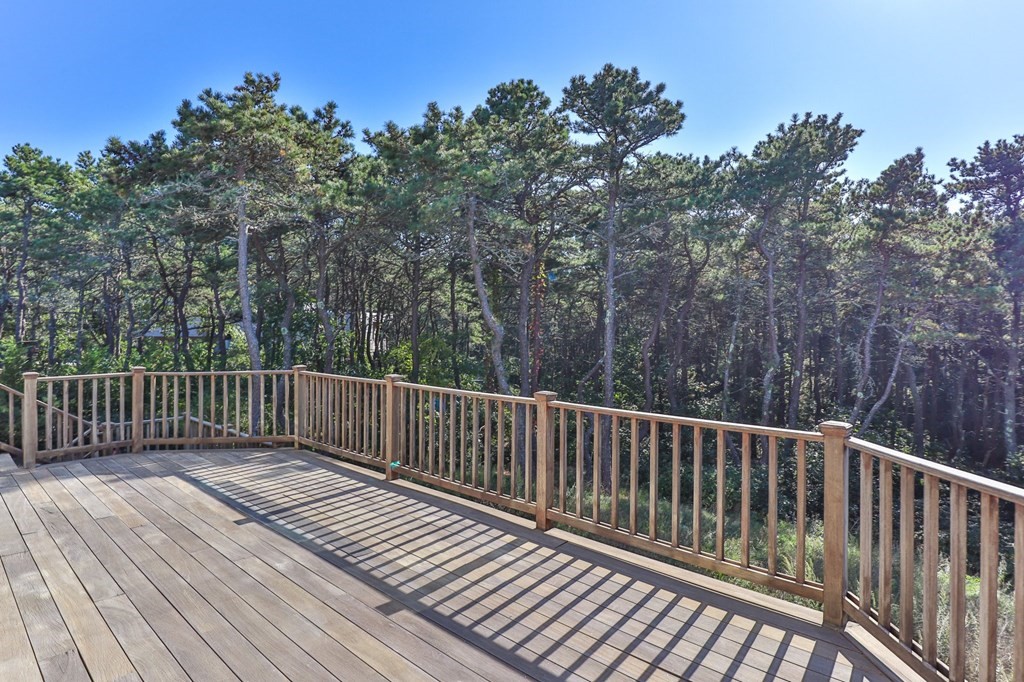 6 Chickadee Lane Truro, MA 02666 - Photo 17 of 42 a balcony with wooden floor and fence