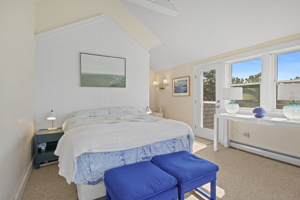 6 Chickadee Lane Truro, MA 02666 - Photo 26 of 42 a spacious bedroom with a bed a couch and dresser