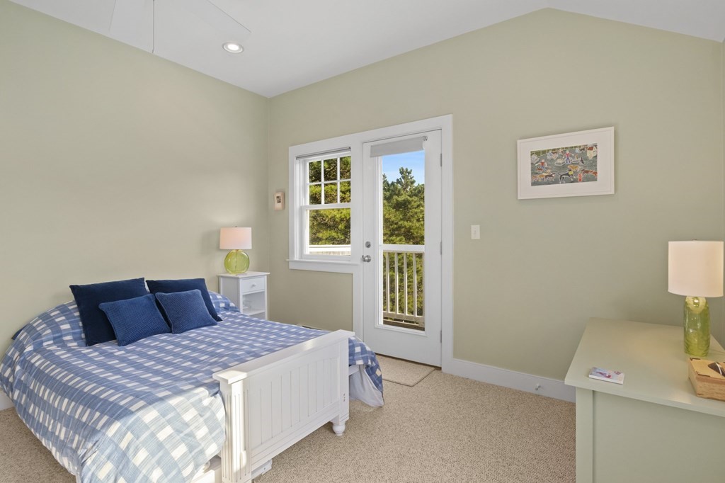 6 Chickadee Lane Truro, MA 02666 - Photo 31 of 42 a bedroom with a bed and a window