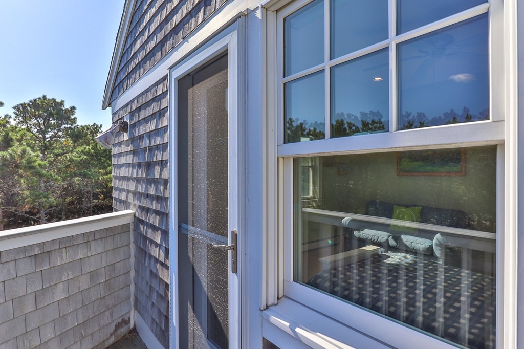 6 Chickadee Lane Truro, MA 02666 - Photo 33 of 42 a balcony with a door