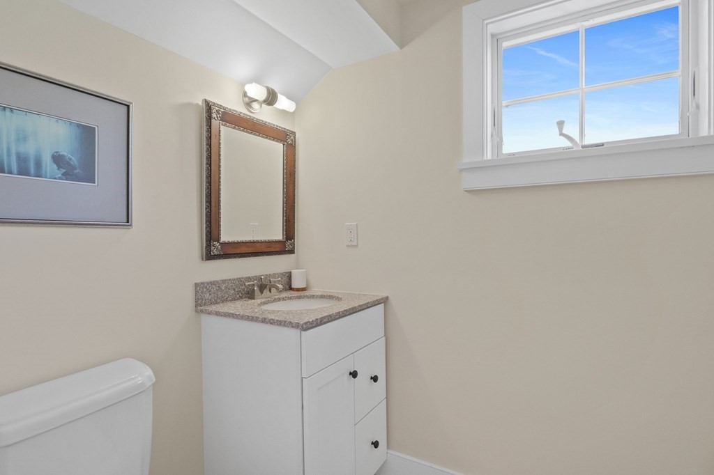 6 Chickadee Lane Truro, MA 02666 - Photo 36 of 42 a bathroom with a granite countertop sink a toilet and a mirror