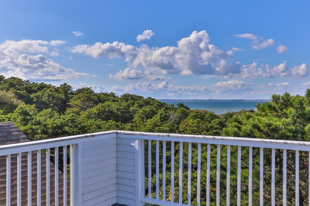6 Chickadee Lane Truro, MA 02666 - Photo 37 of 42 a balcony with a city view