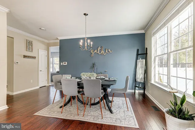 a living room with furniture a ceiling fan and a window