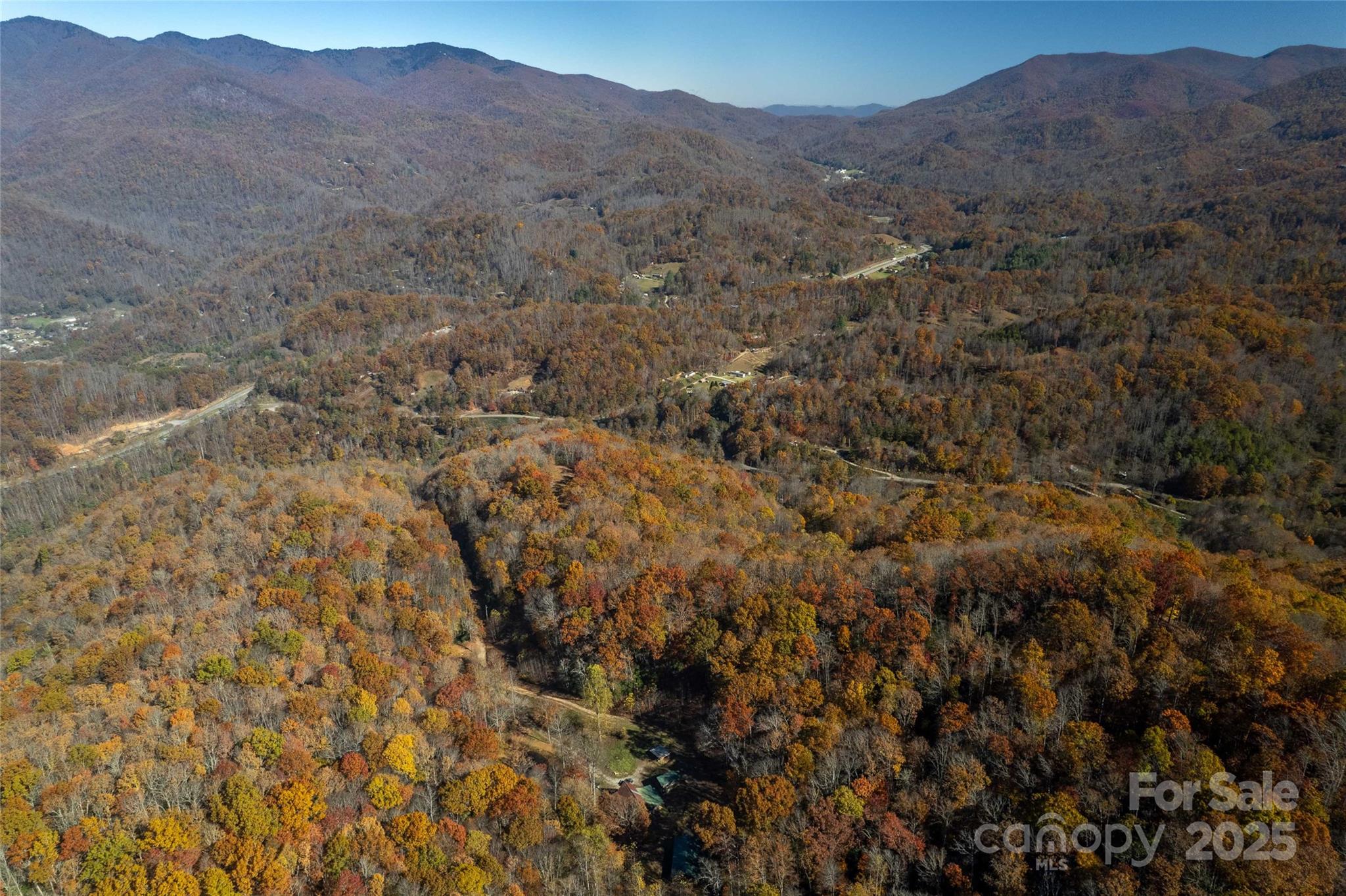 930 Copperhead Cove Road Sylva, NC 28779 - Photo 18 of 48 a view of a dry yard with mountains in the background