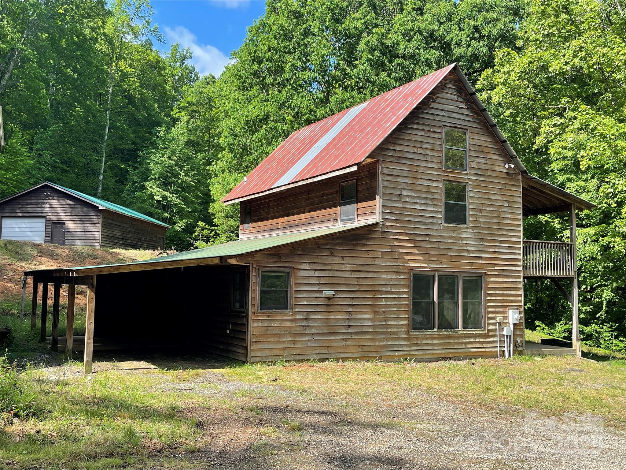 930 Copperhead Cove Road Sylva, NC 28779 - Photo 19 of 48 a view of house with yard and trees in the background