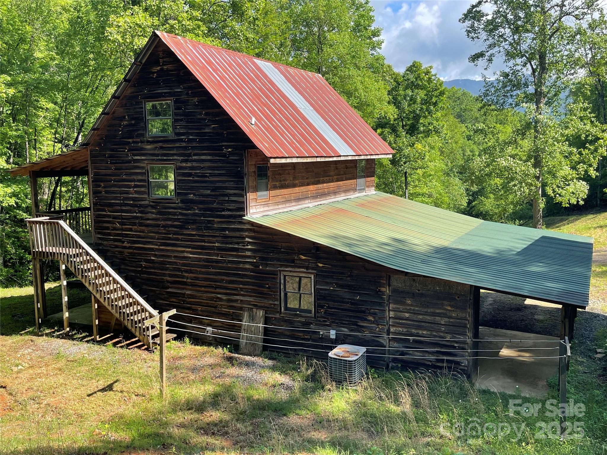 930 Copperhead Cove Road Sylva, NC 28779 - Photo 21 of 48 a backyard of a house with lots of green space