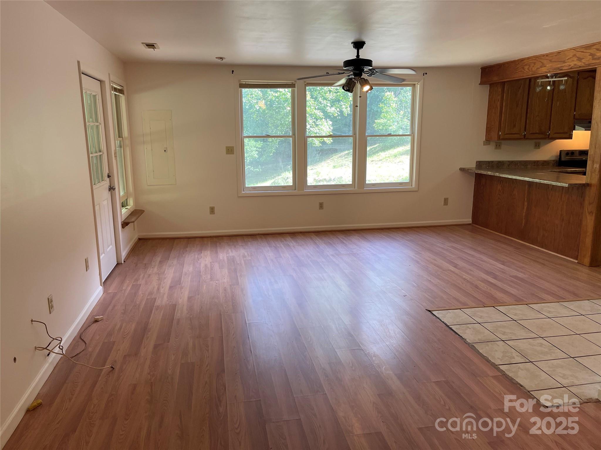 930 Copperhead Cove Road Sylva, NC 28779 - Photo 25 of 48 an empty room with wooden floor and windows