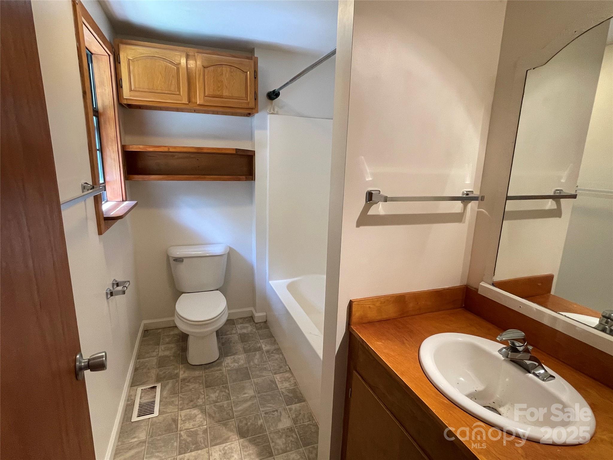 930 Copperhead Cove Road Sylva, NC 28779 - Photo 27 of 48 a bathroom with a sink toilet and shower