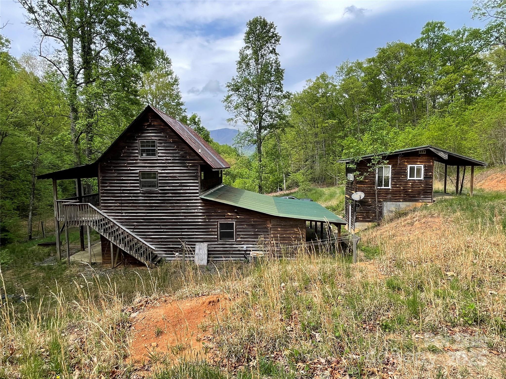 930 Copperhead Cove Road Sylva, NC 28779 - Photo 31 of 48 a view of house with roof deck and a small yard