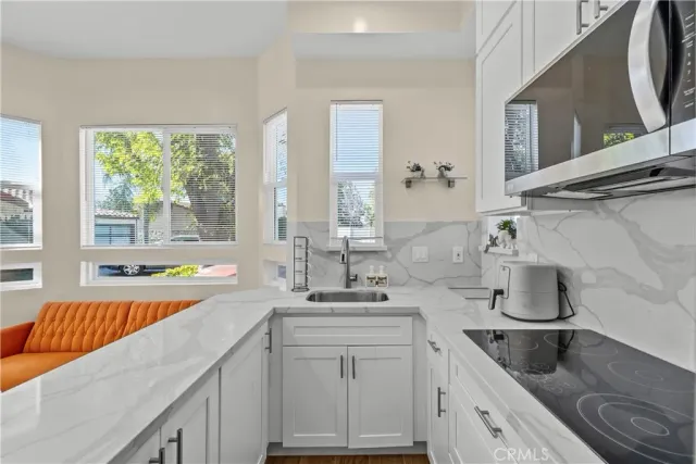 a kitchen with a sink stove and cabinets