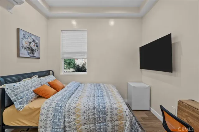 a living room with a rug and a flat screen tv