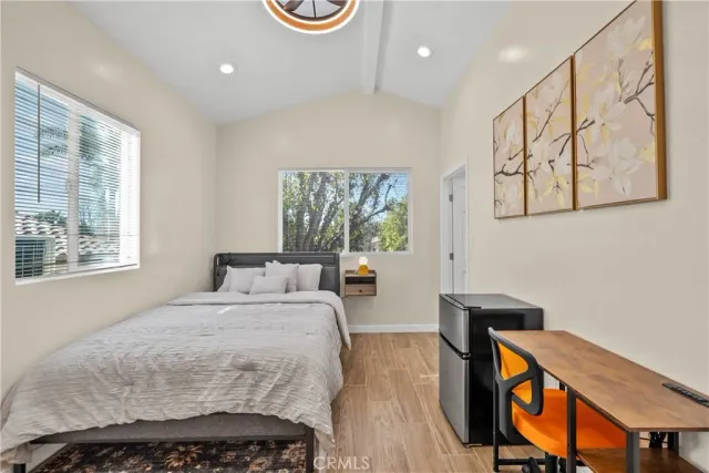 a bedroom with a bed and wooden floor