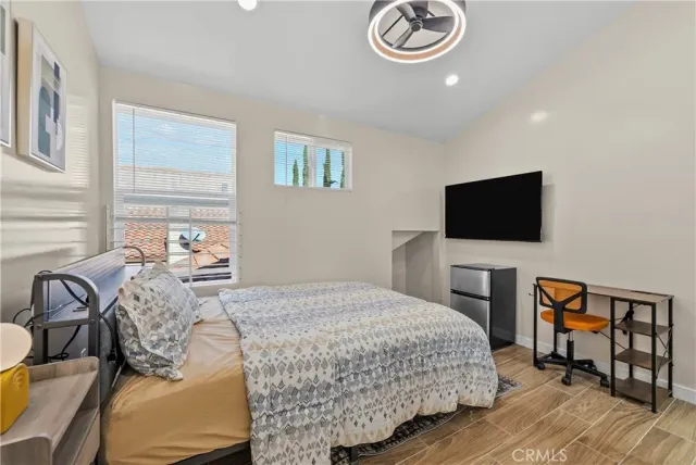 a bedroom with a bed and a flat screen tv