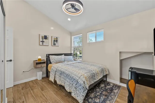 a bedroom with a bed and a lamp on dresser