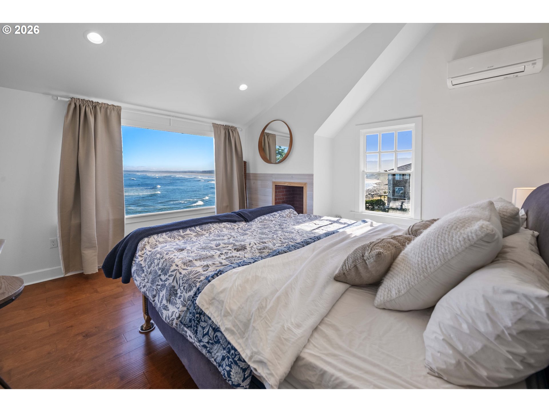 3232 Sunset Boulevard Seaside, OR 97138 - Photo 17 of 48 a bedroom with a bed and a large mirror
