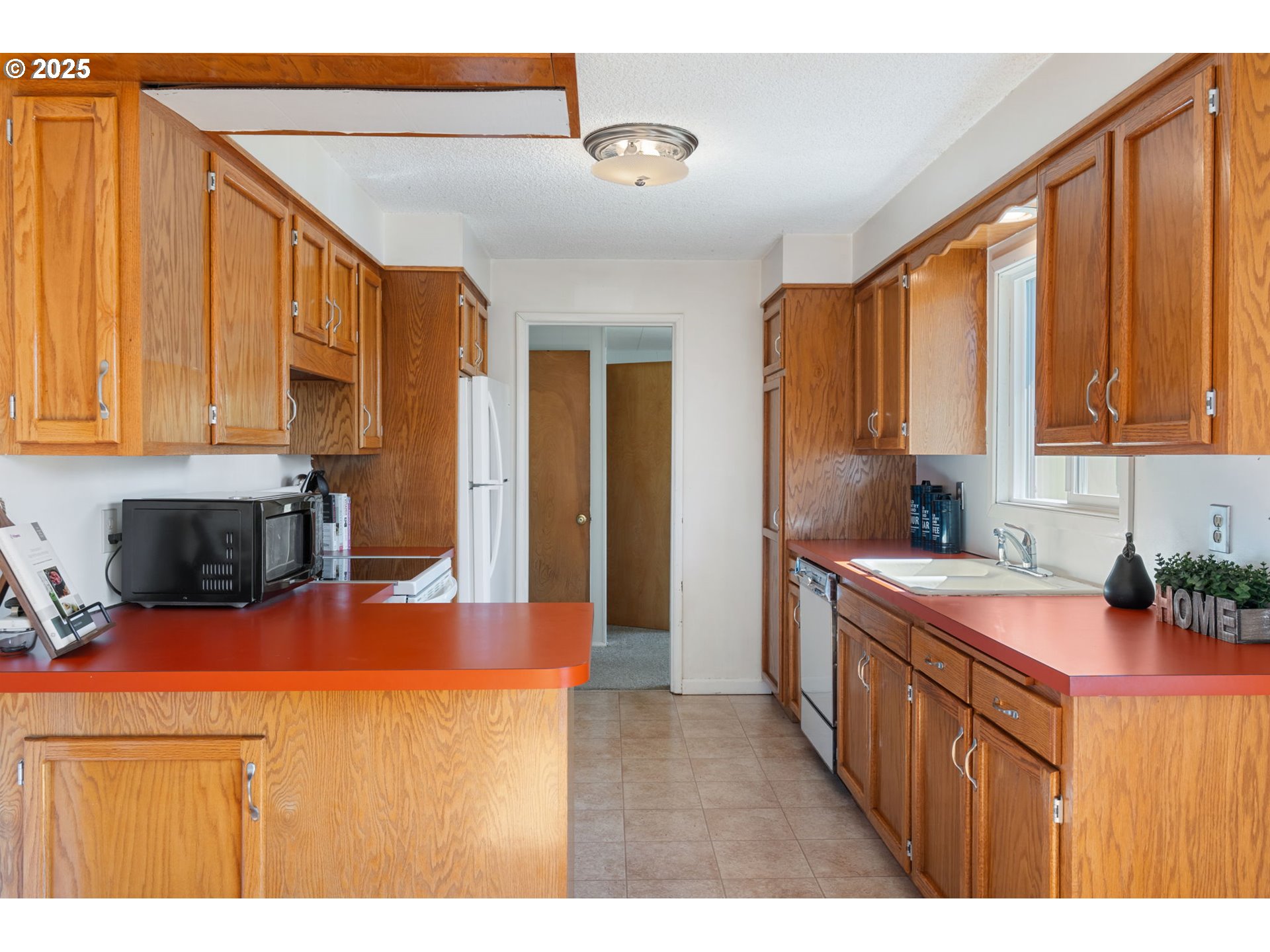 122 Armstrong Road Chehalis, WA 98532 - Photo 12 of 40 a kitchen filled a counter top space a sink a refrigerator and cabinets