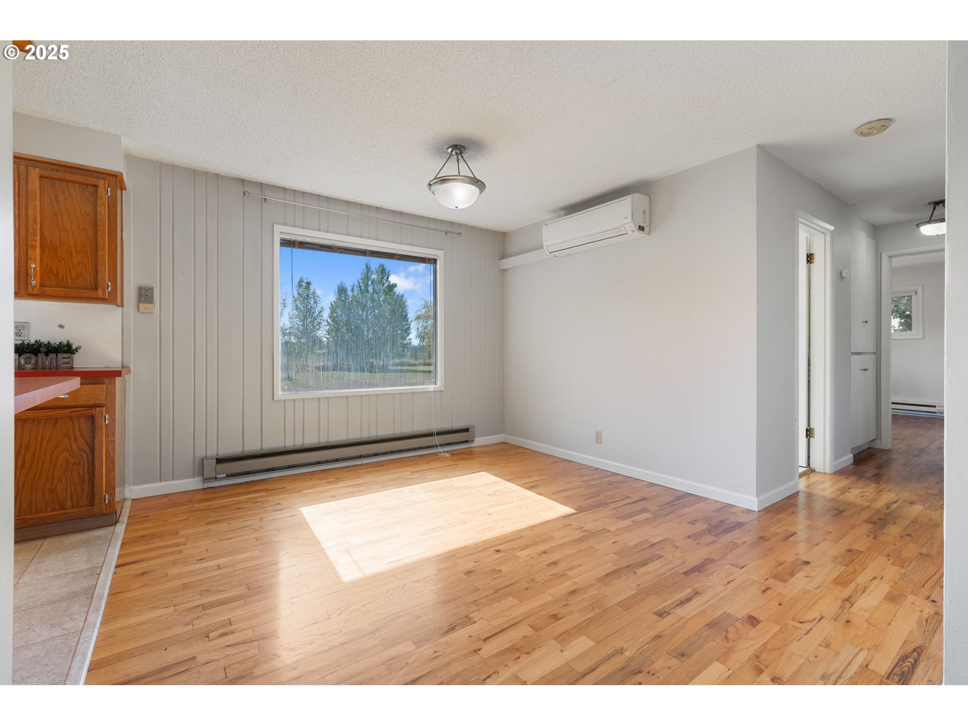122 Armstrong Road Chehalis, WA 98532 - Photo 9 of 40 a view of an empty room with window and wooden floor