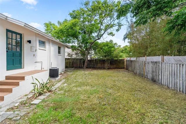 a view of a backyard with a trees and plants