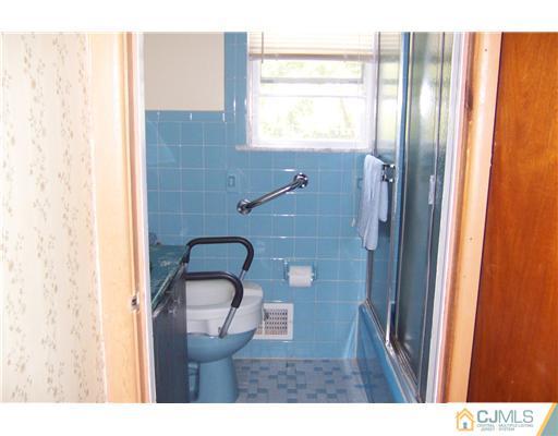 36 West Hill Road Colonia, NJ 07067 - Photo 12 of 14 a bathroom with a sink and a mirror