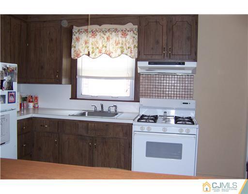 36 West Hill Road Colonia, NJ 07067 - Photo 3 of 14 a kitchen with a sink cabinets and window
