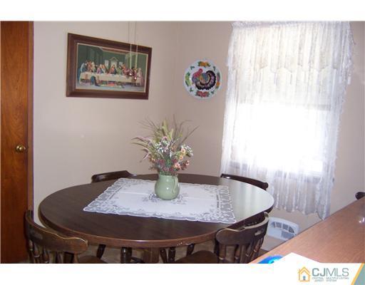 36 West Hill Road Colonia, NJ 07067 - Photo 6 of 14 a table with a vase and flowers on it