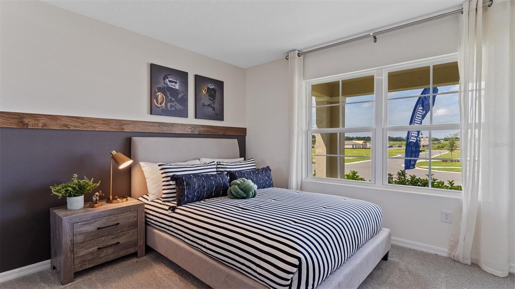 3906 Royal Azalea Way Sanford, FL 32773 - Photo 25 of 44 a bedroom with bed and window