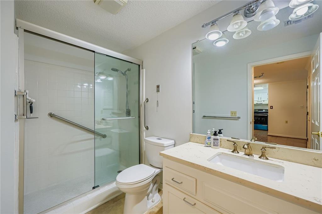 1800 Clairmont Lake, Unit A325 Decatur, GA 30033 - Photo 12 of 51 a bathroom with a shower sink vanity mirror and toilet