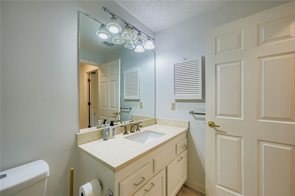 1800 Clairmont Lake, Unit A325 Decatur, GA 30033 - Photo 13 of 51 a bathroom with a sink a light fixture and a mirror