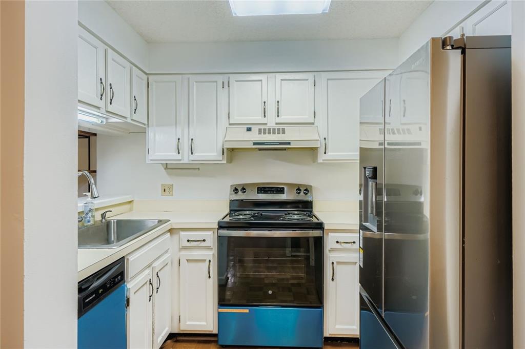 1800 Clairmont Lake, Unit A325 Decatur, GA 30033 - Photo 5 of 51 a kitchen with cabinets stainless steel appliances and a sink