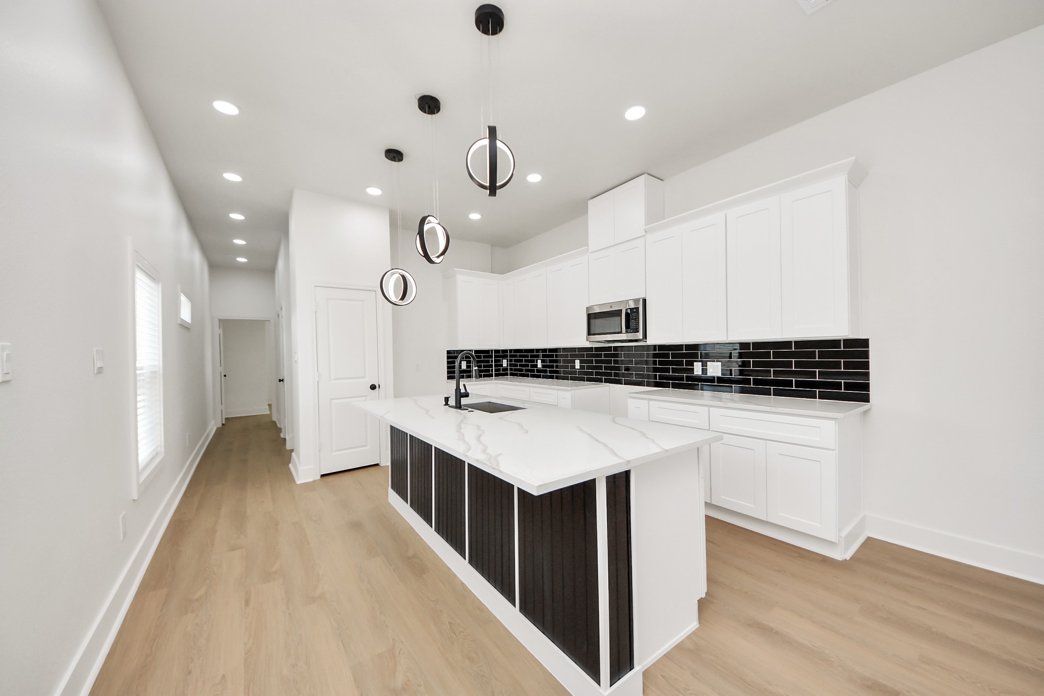 5226 Ricky Street Houston, TX 77033 - Photo 20 of 50 a kitchen that has a lot of cabinets and wooden floor