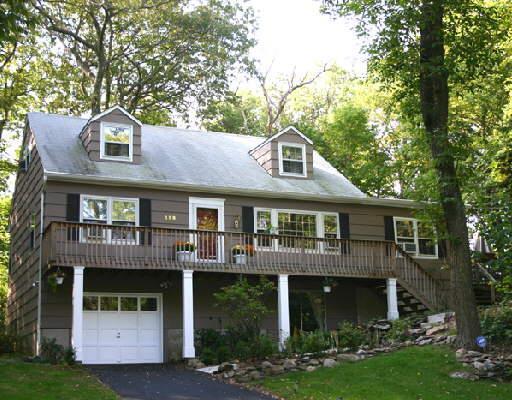 138 Bob Hill Road Ridgefield, CT 06877 - Photo 1 of 1 a front view of a house with a yard and garage