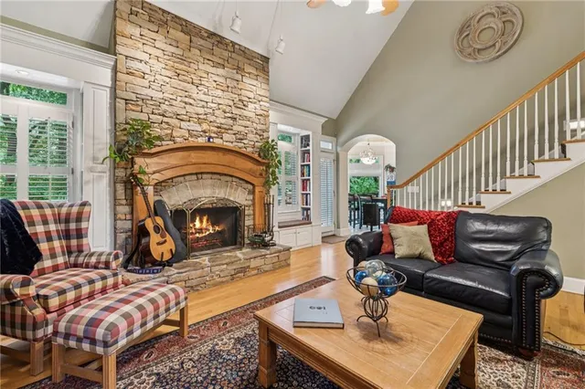 a living room with furniture a flat screen tv and a table