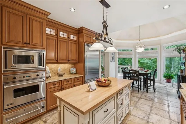 a kitchen with a stove a sink and a refrigerator