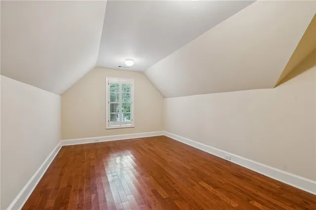 a bathroom with a sink a mirror a vanity and a shower