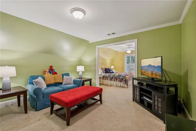 a view of a livingroom with furniture and a ceiling fan
