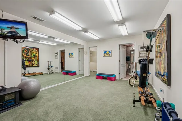 a kitchen with a refrigerator sink and cabinets