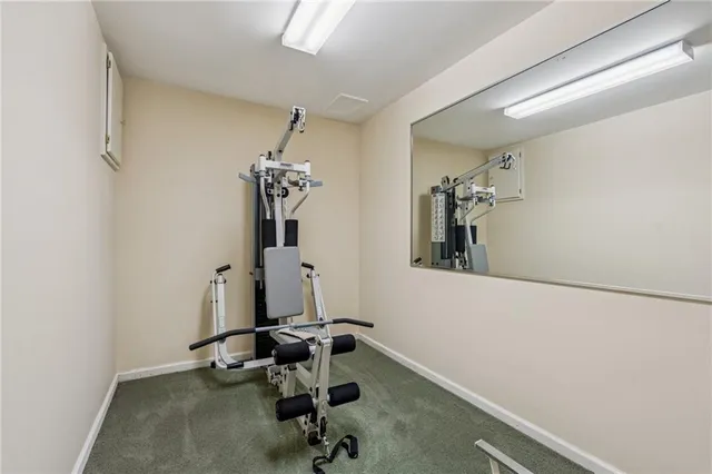 a view of a patio with table and chairs floor to ceiling window with wooden fence