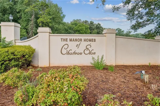 a front view of a house with a garden and plants