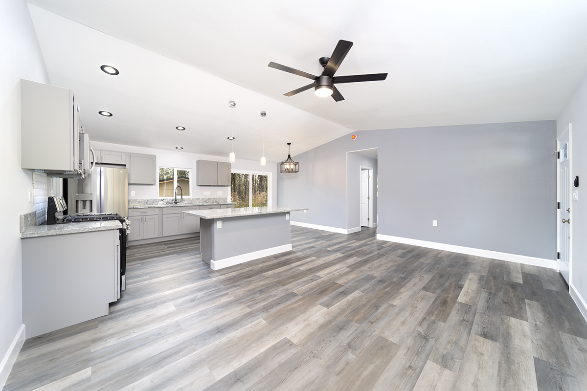 11-3115 Mokuna Street Mountain View, HI 96771 - Photo 13 of 30 a living room with kitchen island and a ceiling fan