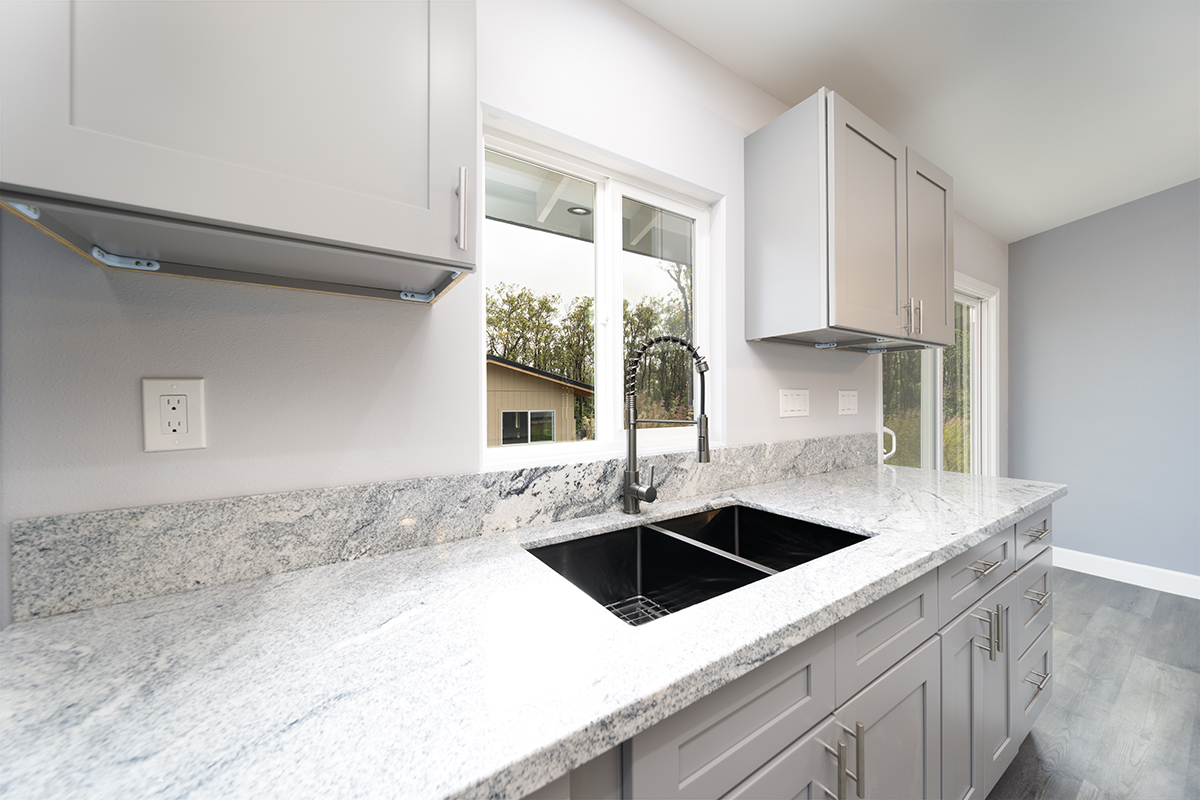 11-3115 Mokuna Street Mountain View, HI 96771 - Photo 18 of 30 a kitchen that has a sink and a stove