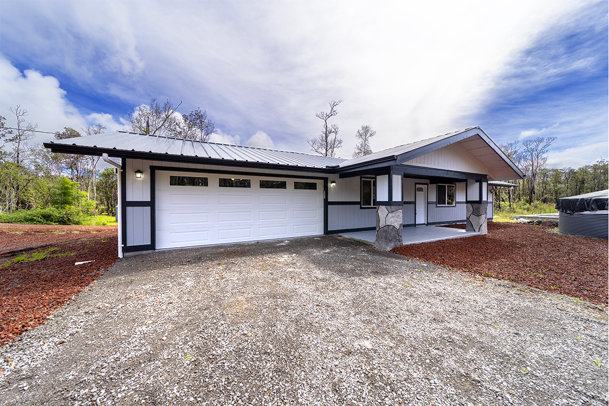 11-3115 Mokuna Street Mountain View, HI 96771 - Photo 6 of 30 a front view of a house with a yard and garage