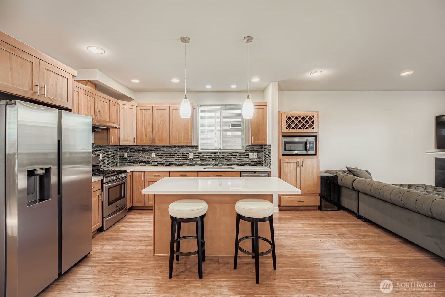 12420 2nd Place Southwest Seattle, WA 98146 - Photo 13 of 31 a kitchen with stainless steel appliances granite countertop a table chairs sink refrigerator and microwave
