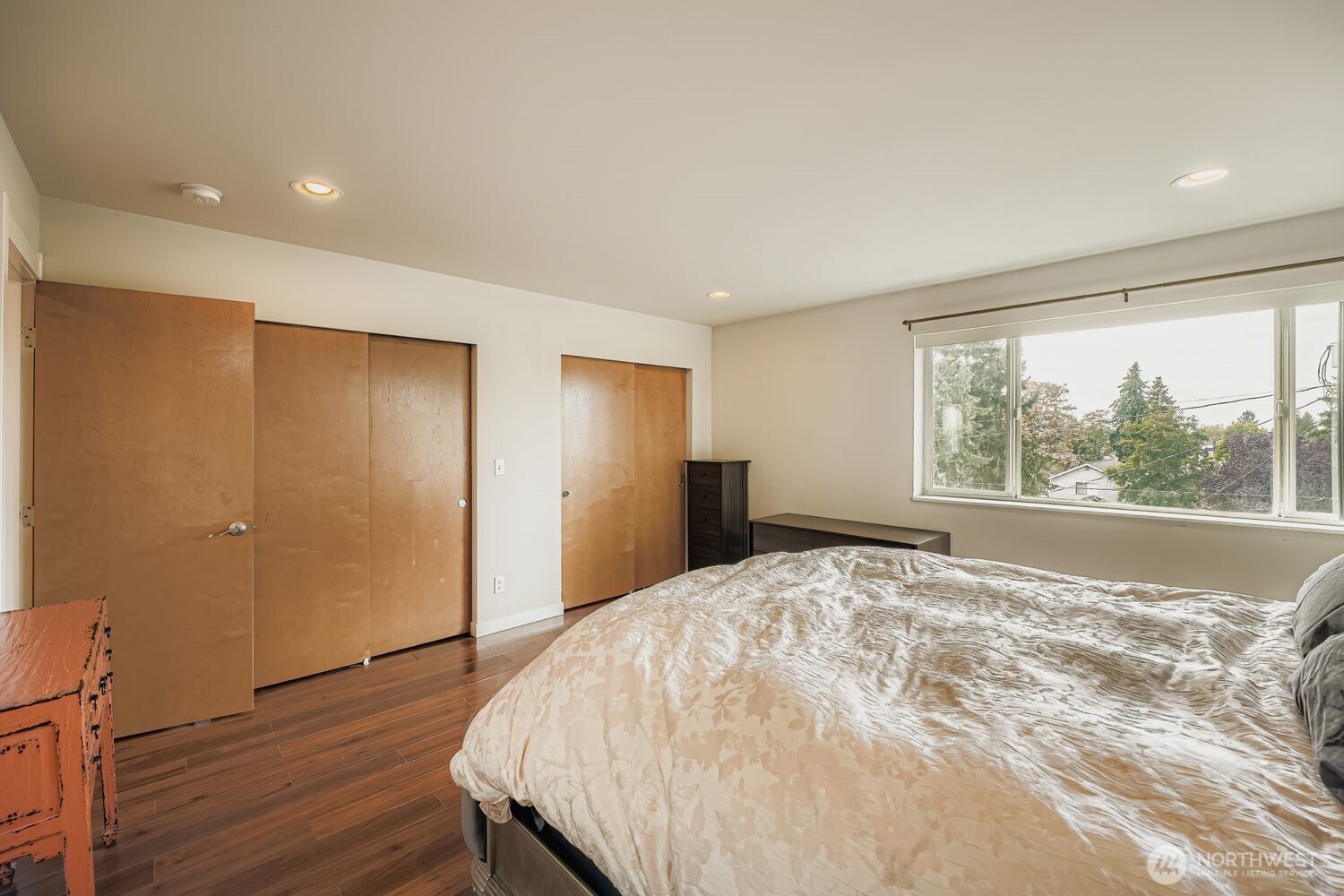 12420 2nd Place Southwest Seattle, WA 98146 - Photo 21 of 31 a large bedroom with wooden floor and a window
