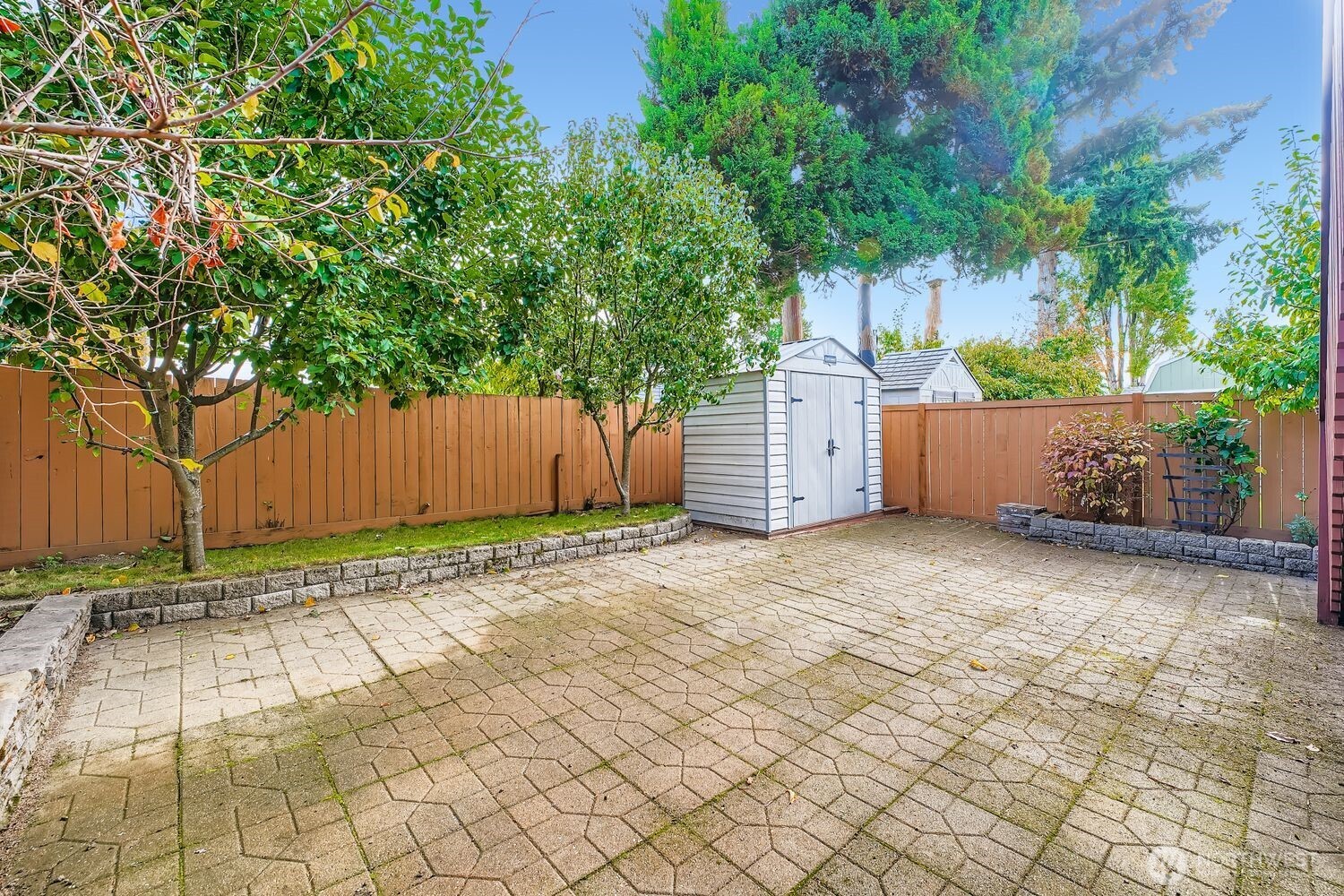 12420 2nd Place Southwest Seattle, WA 98146 - Photo 28 of 31 a row of white house with a large tree and wooden fence