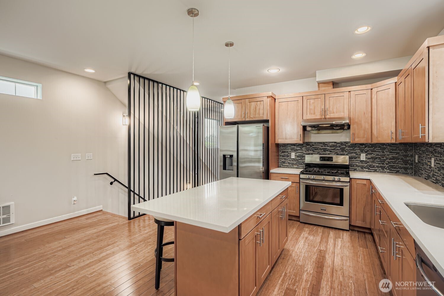 12420 2nd Place Southwest Seattle, WA 98146 - Photo 8 of 31 a kitchen with stainless steel appliances kitchen island a refrigerator sink and cabinets