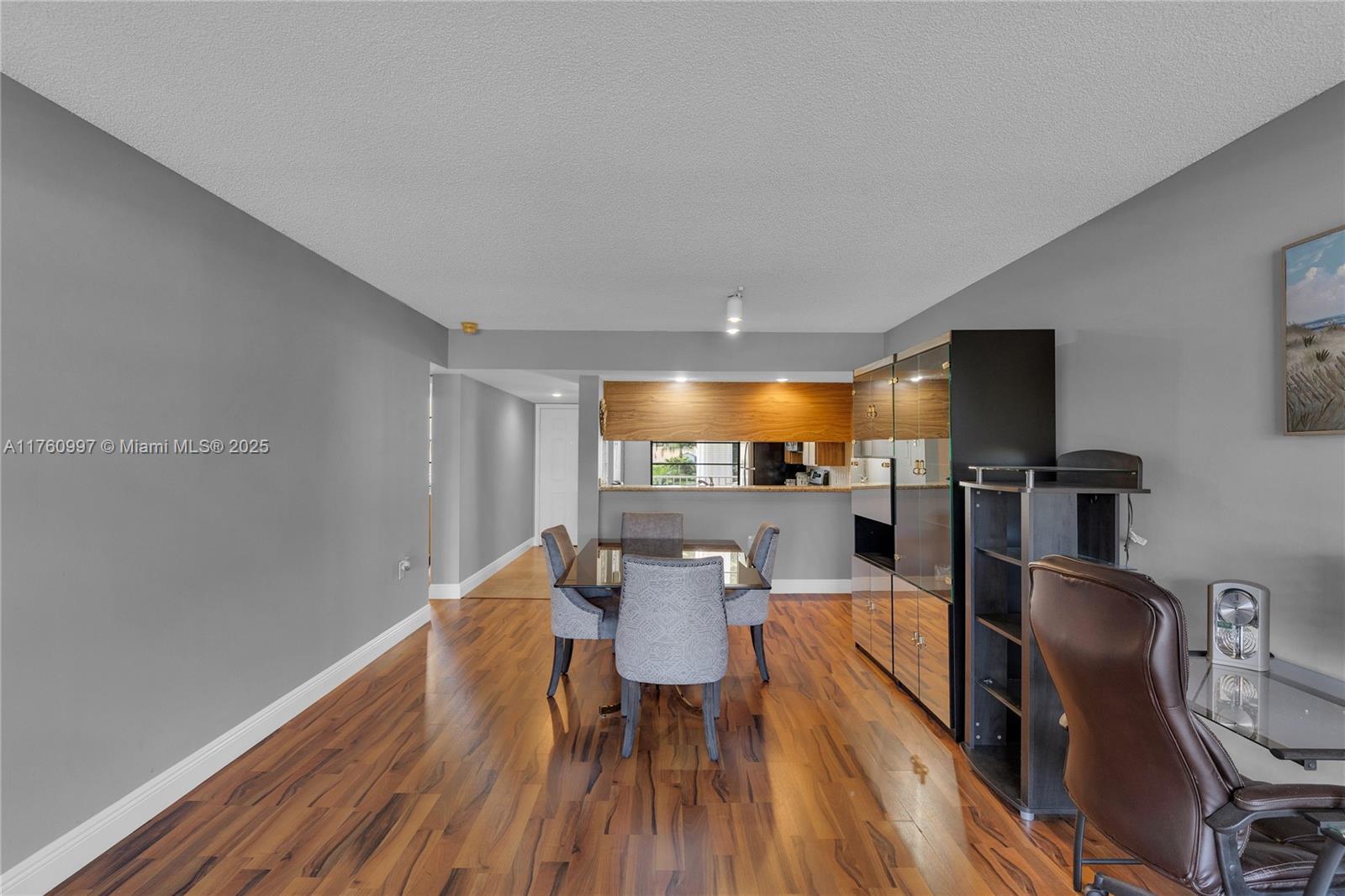 6025 Balboa Circle, Unit 204 Boca Raton, FL 33433 - Photo 11 of 38 a view of a dining room with furniture window and wooden floor