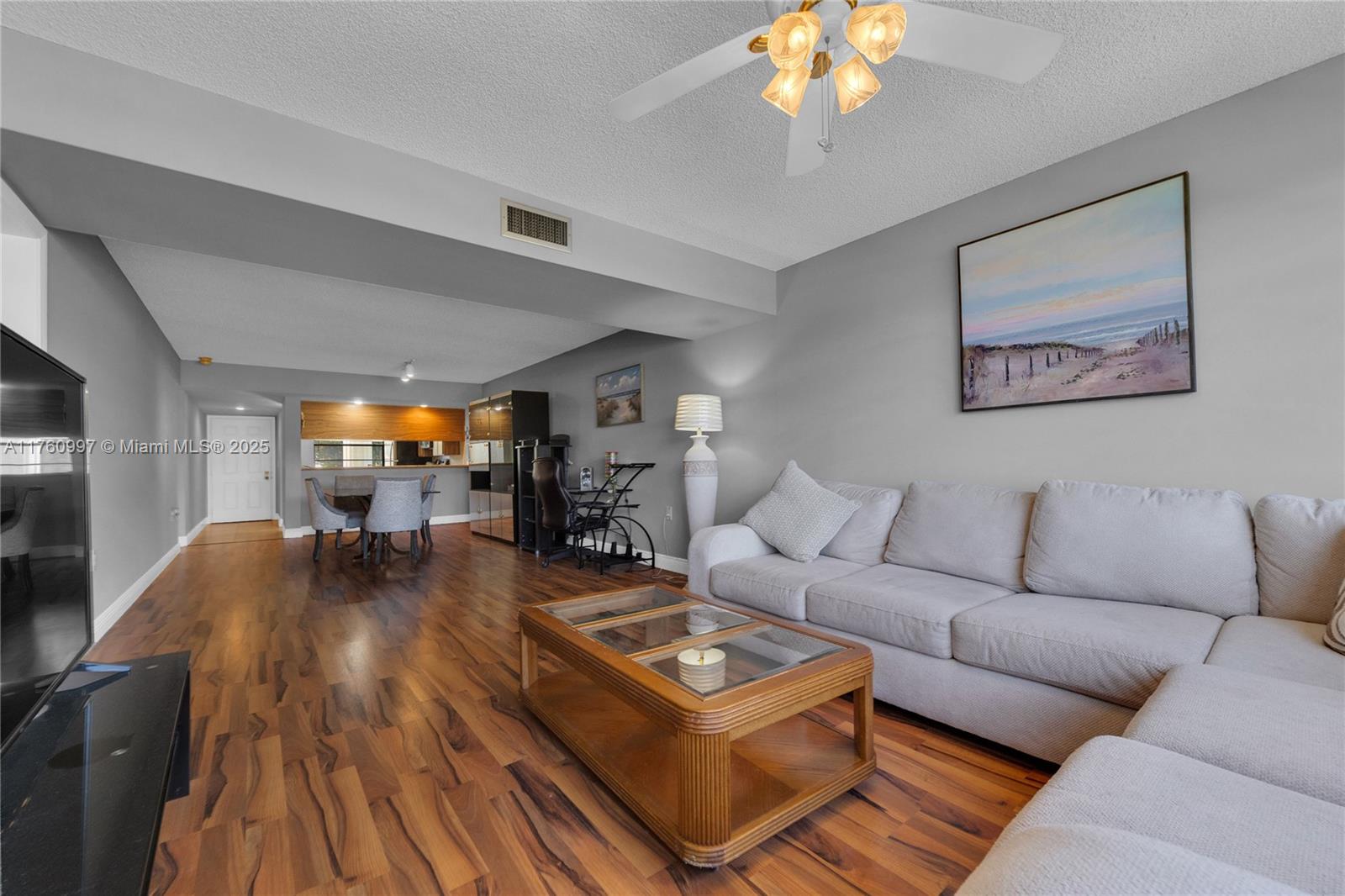 6025 Balboa Circle, Unit 204 Boca Raton, FL 33433 - Photo 12 of 38 a living room with furniture a chandelier and a dining table