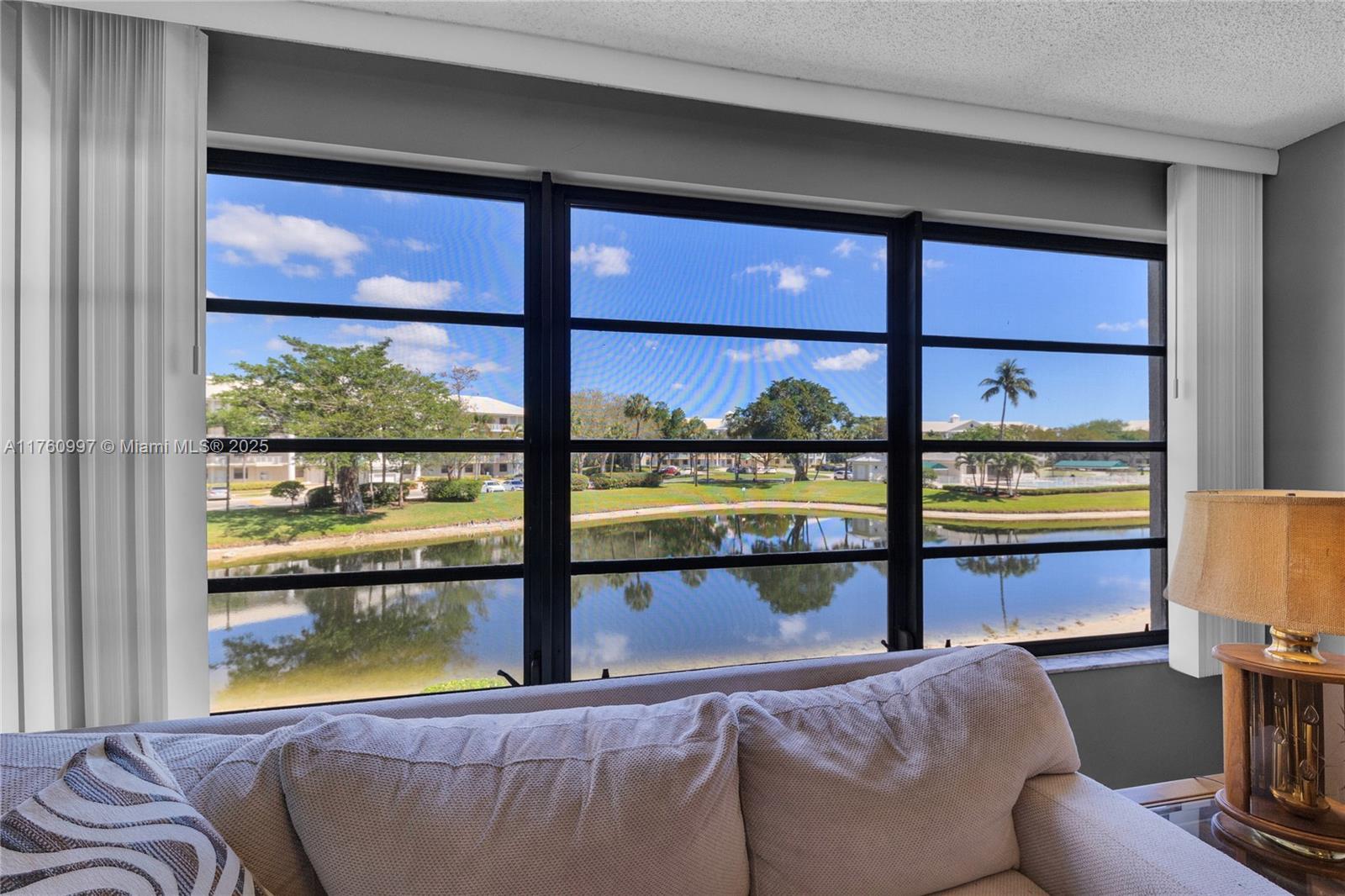 6025 Balboa Circle, Unit 204 Boca Raton, FL 33433 - Photo 13 of 38 a living room with a large window