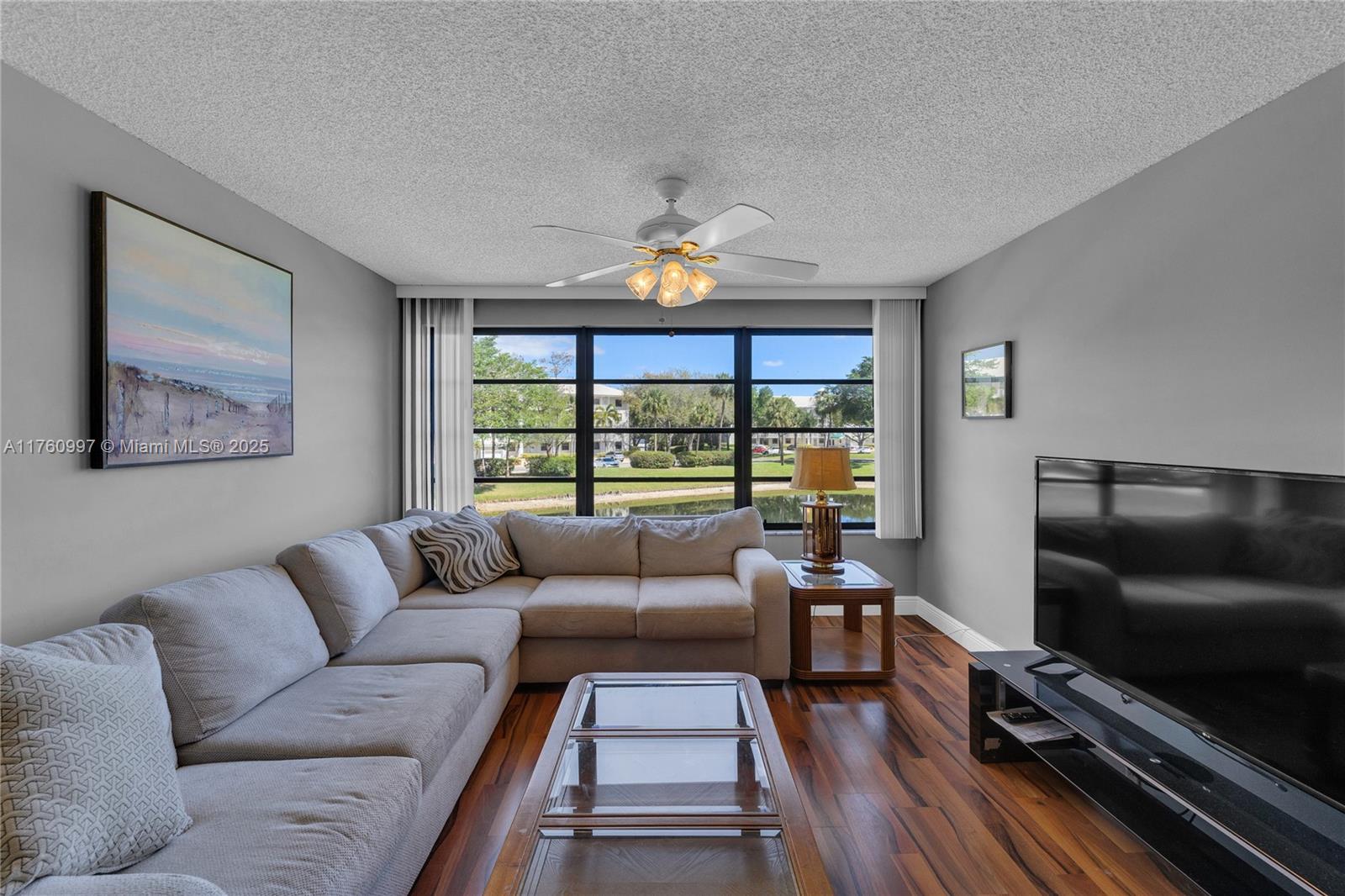 6025 Balboa Circle, Unit 204 Boca Raton, FL 33433 - Photo 14 of 38 a living room with furniture and a flat screen tv