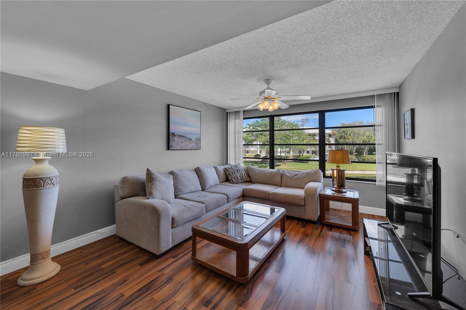 6025 Balboa Circle, Unit 204 Boca Raton, FL 33433 - Photo 15 of 38 a living room with furniture and a floor to ceiling window